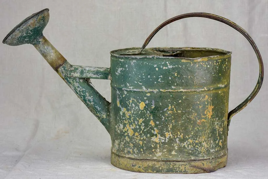 Antique French watering can with green patina